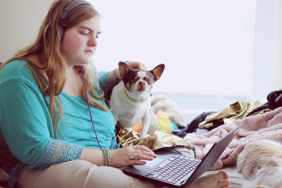 A 19-year-old woman with Autism and other learning disabilities using her laptop to study remotely.