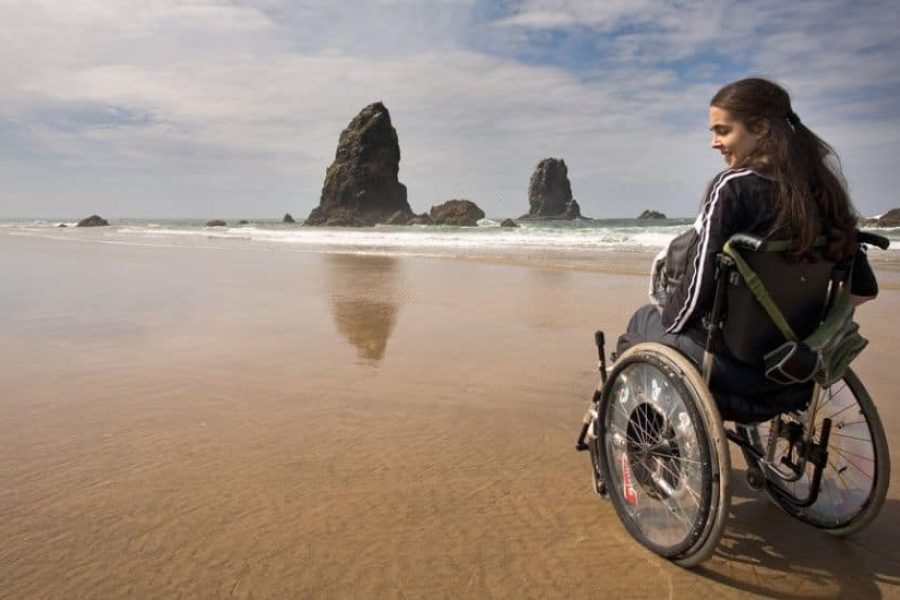 Young women in wheelchair on the beach